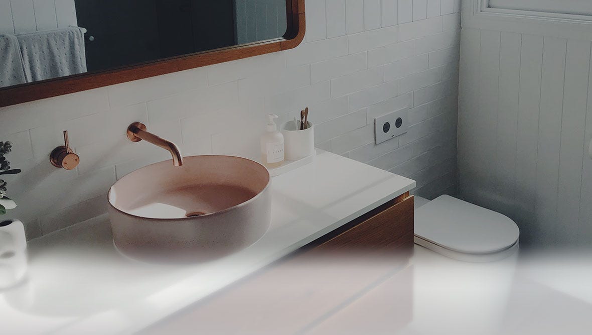 Modern bathroom with a brass vessel sink.